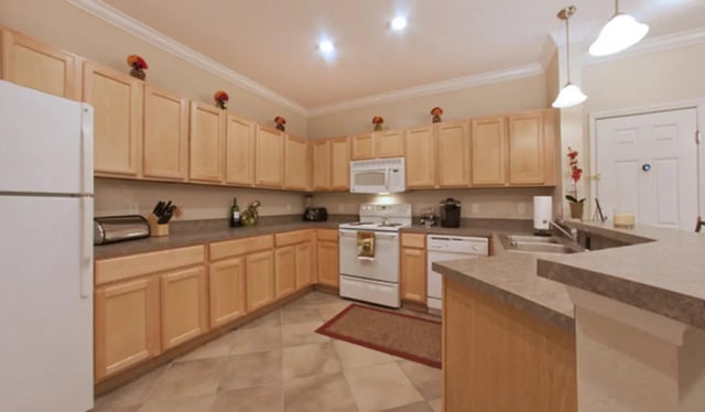 Kitchen with light wood cabinets oven microwave and refrigerator kitchen at Stratford Court Luxury Apartments in Gainesville Student Accommodation