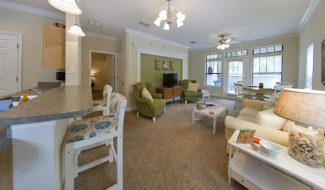 Kitchen island chairs green chairs sofa living room at Stratford Court Luxury Apartments in Gainesville Student Accommodation