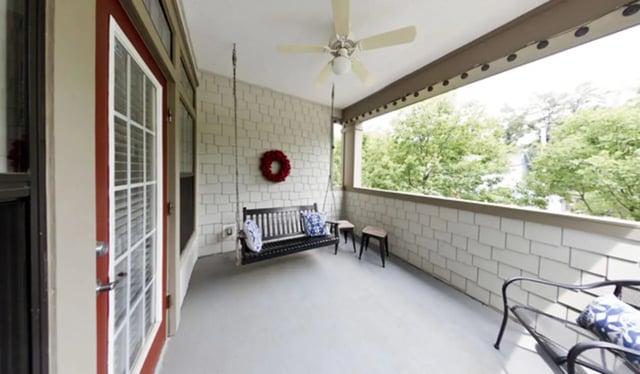 Porch swing bench cushions and stools exterior at Stratford Court Luxury Apartments in Gainesville Student Accommodation