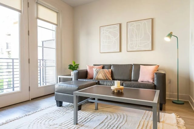 Sofa coffee table artwork floor lamp living room at The Eden Apartments in Cincinnati Student Accommodation