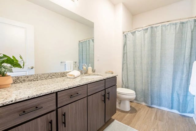 Toilet sink vanity and shower curtain bathroom at The Eden Apartments in Cincinnati Student Accommodation