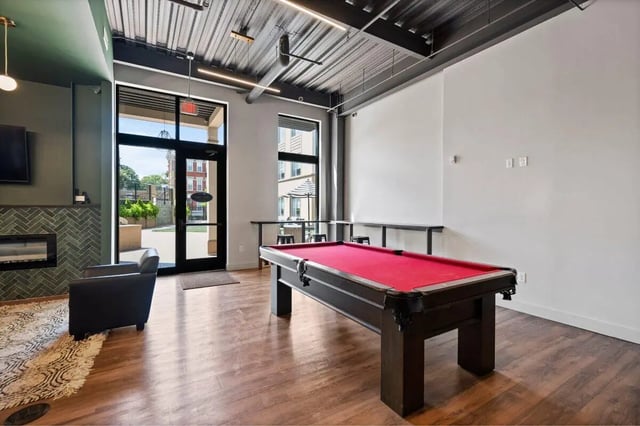 Pool table armchair fireplace playing area at The Eden Apartments in Cincinnati Student Accommodation