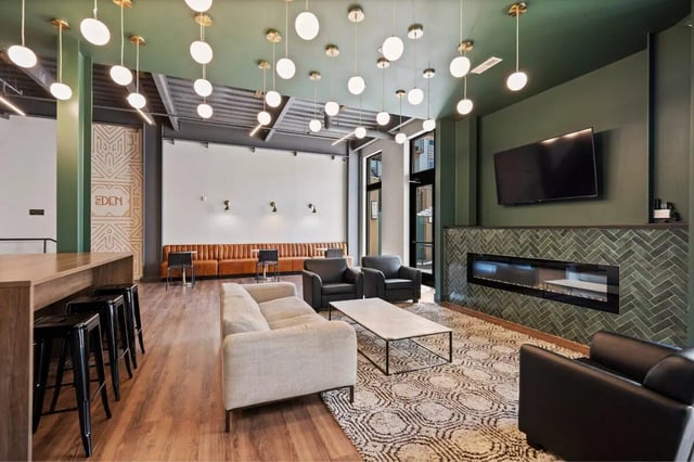 Sofas coffee table fireplace seating lounge area at The Eden Apartments in Cincinnati Student Accommodation