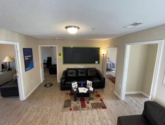 Black couches with coffee table living room at Campus East Apartments in Greensboro Student Accommodation