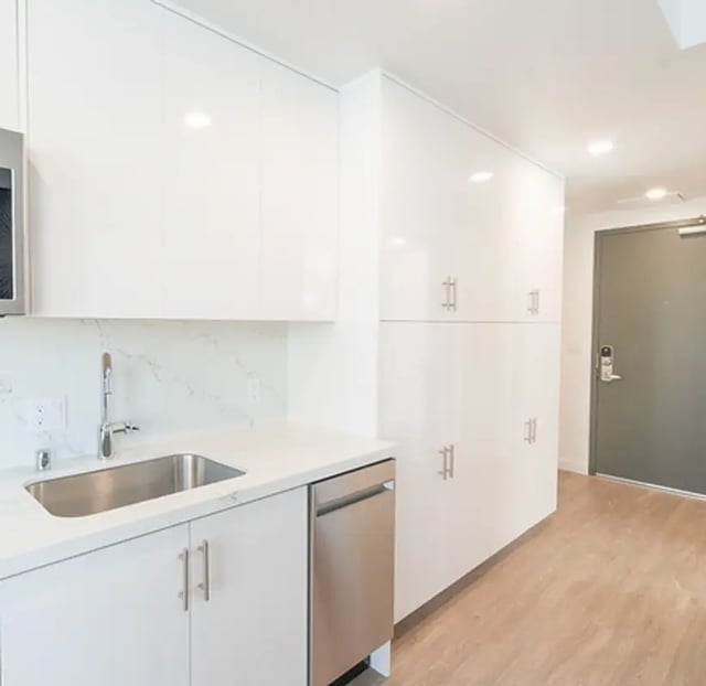 White cabinets sink and dishwasher kitchen at Aquatic at U in Berkeley Student Accommodation