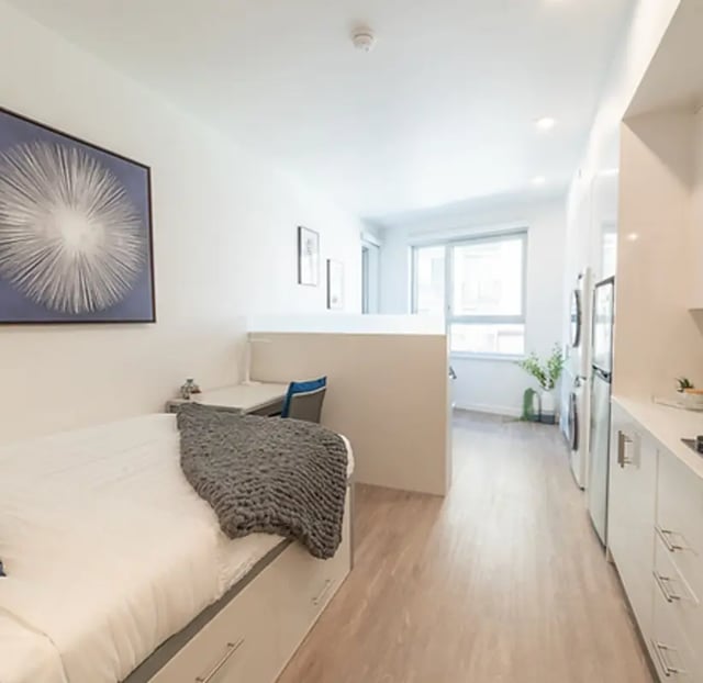 Bed desk and kitchen area living room at Aquatic at U in Berkeley Student Accommodation