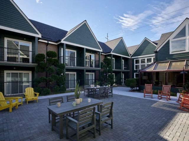 Paved courtyard with seating and balconies exterior at Abigail Court in Gresham Student Accommodation