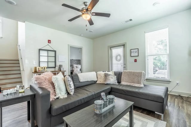Large sectional couch with decorative pillows living room at Boulevard in Milledgeville Student Accommodation