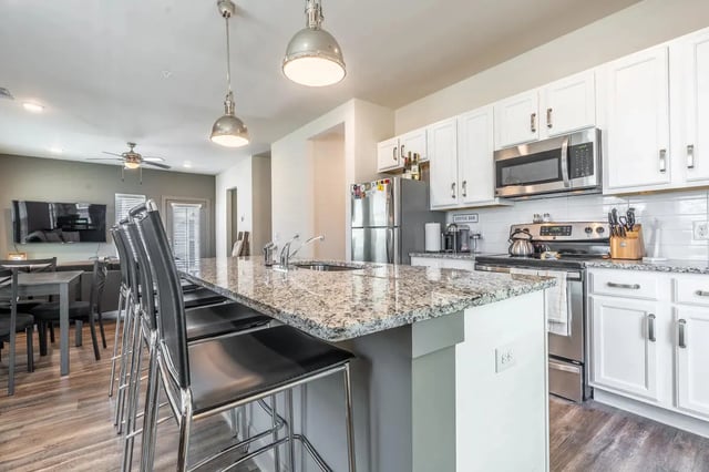 Kitchen island with bar stools and appliances kitchen at Boulevard in Milledgeville Student Accommodation
