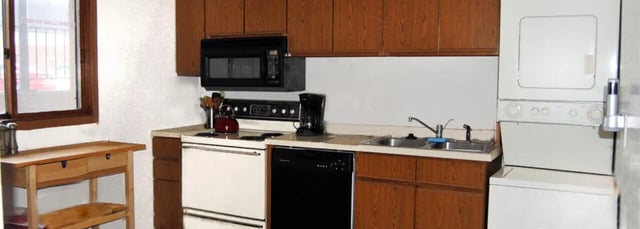 Microwave oven stove sink dishwasher dryer kitchen at Cardinal Apartments in DeKalb Student Accommodation