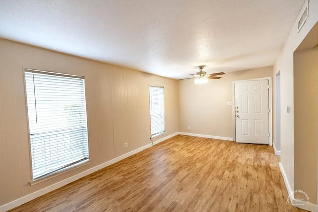 Empty living area with wood floor ceiling fan door living room at Barranca Square Student Apartments in Austin Student Accommodation