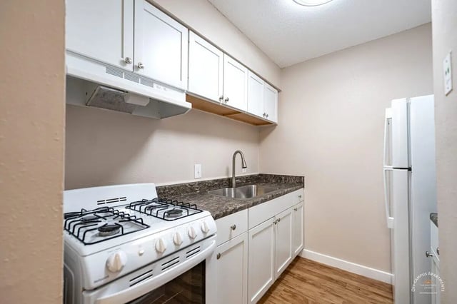White stove sink cabinets and refrigerator kitchen at Barranca Square Student Apartments in Austin Student Accommodation