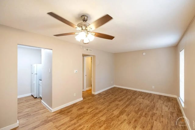 Room with ceiling fan and kitchen visible Living room at Barranca Square Student Apartments in Austin Student Accommodation