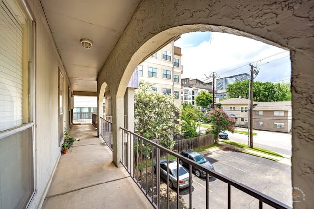 Balcony view with parking lot and apartments exterior at Barranca Square Student Apartments in Austin Student Accommodation