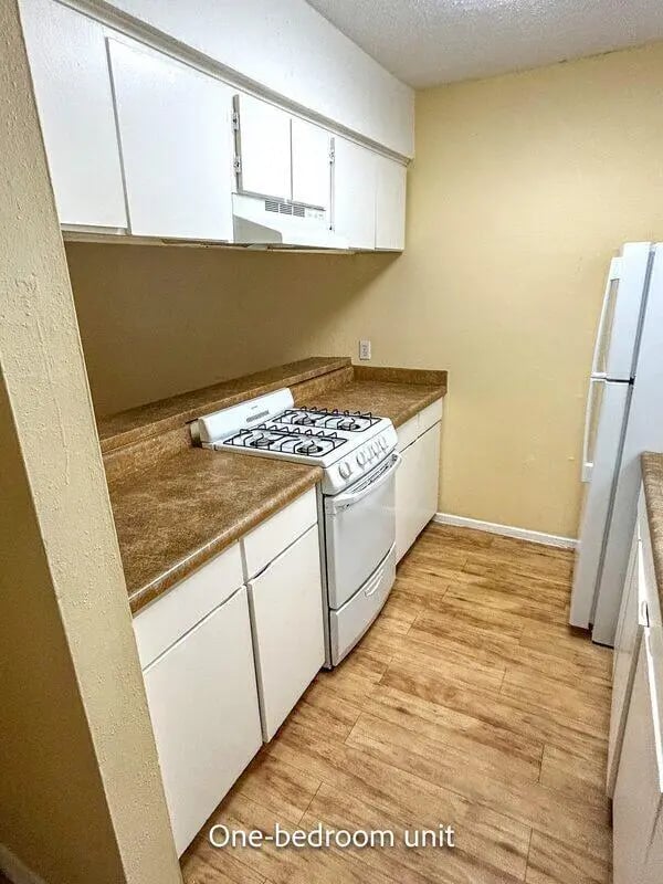 White cabinets white stove and refrigerator kitchen at Barranca Square Student Apartments in Austin Student Accommodation