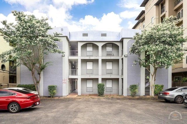 Apartment building with balconies and cars exterior at Barranca Square Student Apartments in Austin Student Accommodation