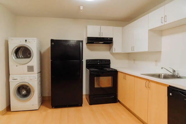 Washing machines refrigerator stove sink cabinets kitchen at Copper Beech Commons Student Housing in Syracuse Student Accommodation