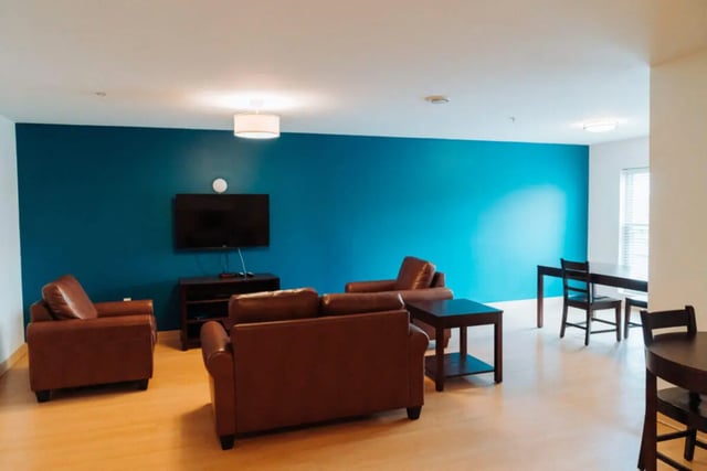 Brown sofas television table and chairs living room at Copper Beech Commons Student Housing in Syracuse Student Accommodation