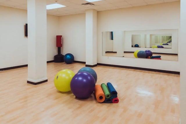 Exercise balls yoga mats punching bag fitness room at Copper Beech Commons Student Housing in Syracuse Student Accommodation
