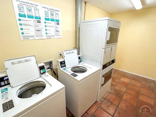 Two washers and a stacked dryer laundry room at Barranca Square Student Apartments in Austin Student Accommodation