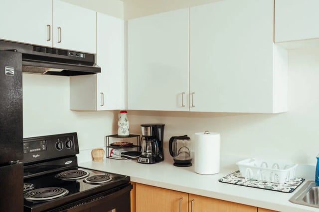 Black refrigerator coffee maker paper towels kitchen at Copper Beech Commons Student Housing in Syracuse Student Accommodation