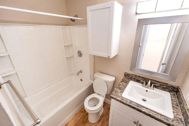 White bathtub toilet sink and cabinet bathroom at Barranca Square Student Apartments in Austin Student Accommodation