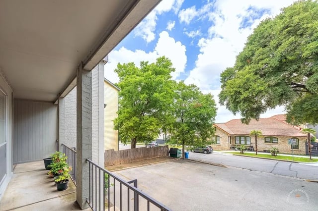 Balcony with potted plants and parking lot exterior at Barranca Square Student Apartments in Austin Student Accommodation