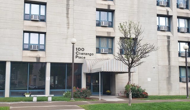 Building entrance with awning and air conditioners exterior at 100 Chenango Place in Binghamton Student Accommodation