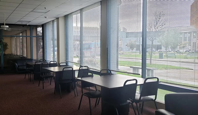 Tables chairs couch large windows shared space at 100 Chenango Place in Binghamton Student Accommodation