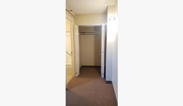 Empty closet and hallway leading to bathroom interior at 100 Chenango Place in Binghamton Student Accommodation