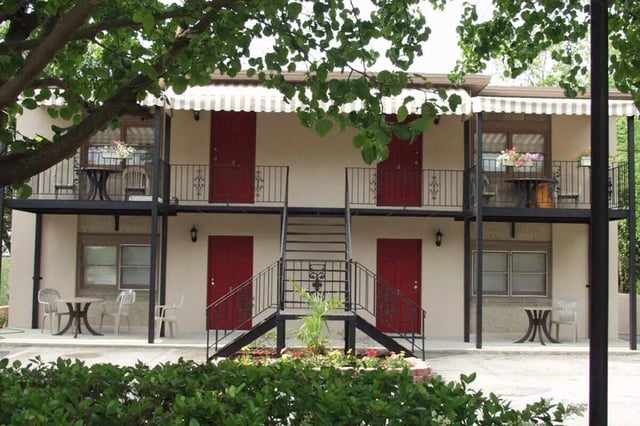 Two story building with red doors balconies exterior at Barristers Hall in Macon Student Accommodation