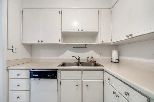 Sink dishwasher and white cabinets kitchen at Barristers Hall in Macon Student Accommodation
