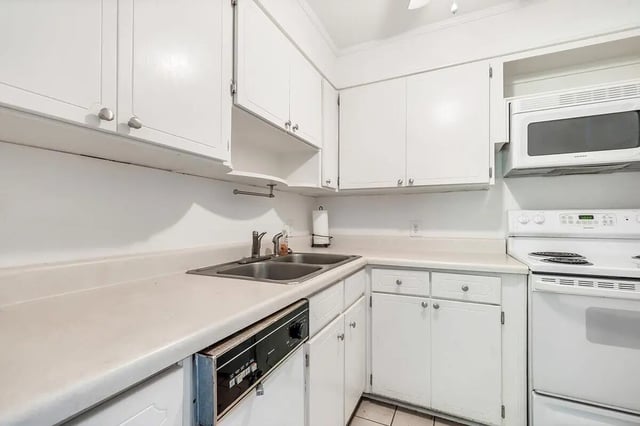 White cabinets sink dishwasher stove microwave kitchen at Barristers Hall in Macon Student Accommodation