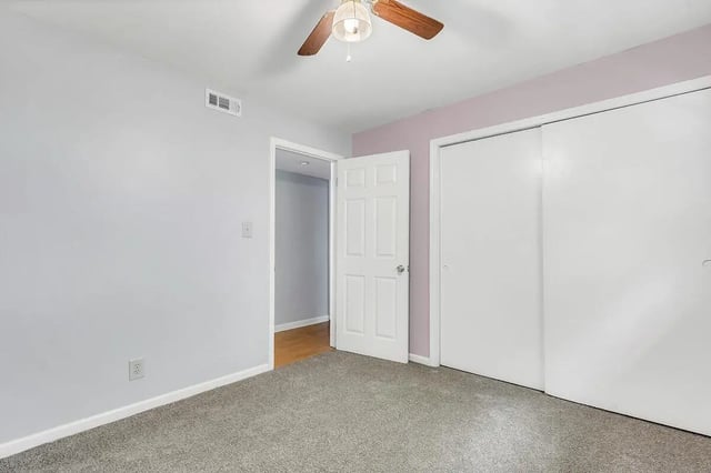 Light gray walls white doors ceiling fan bedroom at Barristers Hall in Macon Student Accommodation