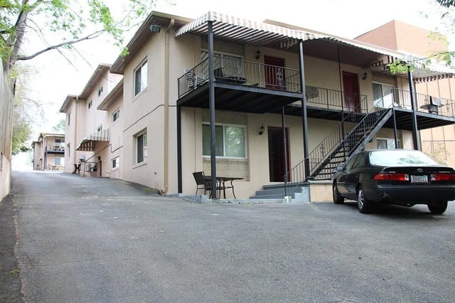 Apartment building with car and stairs exterior at Barristers Hall in Macon Student Accommodation