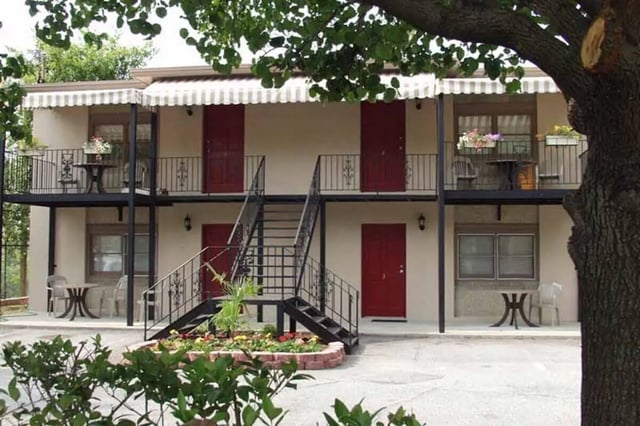 Exterior building with balconies tables and doors Exterior at Barristers Hall in Macon Student Accommodation
