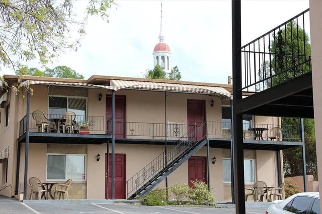 Apartment building with balconies tables chairs exterior at Barristers Hall in Macon Student Accommodation