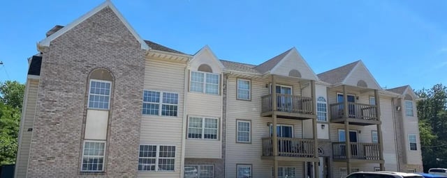 Brick and siding building with balconies exterior at Bowers Rentals in Charleston Student Accommodation