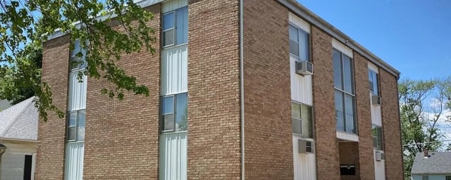 Brick building with windows and air conditioners exterior at Bowers Rentals in Charleston Student Accommodation