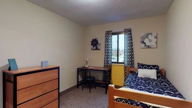 Bed desk dresser and artwork bedroom at Bayit Edinboro in Edinboro Student Accommodation