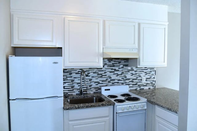 White refrigerator sink stove cabinets kitchen at Campus Walk at ECU in Greenville Student Accommodation