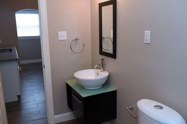 Sink mirror towel rack toilet bathroom at Campus Walk at ECU in Greenville Student Accommodation
