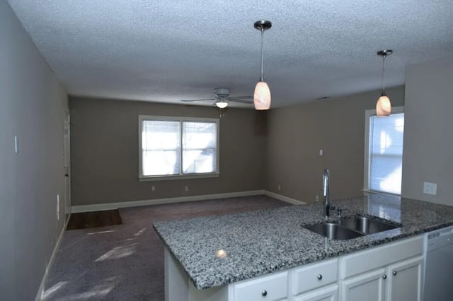 Granite island with sink and pendant lights kitchen at Campus Walk at ECU in Greenville Student Accommodation