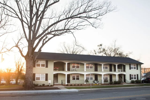 Light green apartment building with balconies exterior at Campus Walk at ECU in Greenville Student Accommodation