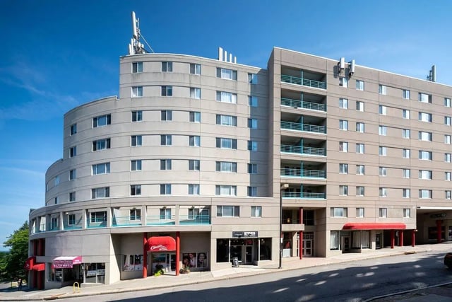 Curved building with balconies and storefronts exterior at 407 College Ave in Ithaca Student Accommodation