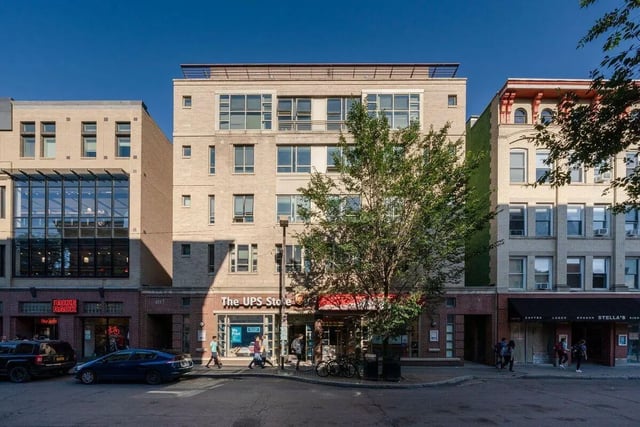 Apartment building with glass storefronts and windows exterior at 407 College Ave in Ithaca Student Accommodation