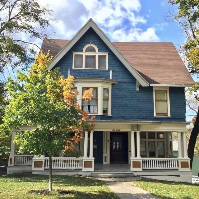 Blue house with porch and trees exterior at 407 College Ave in Ithaca Student Accommodation