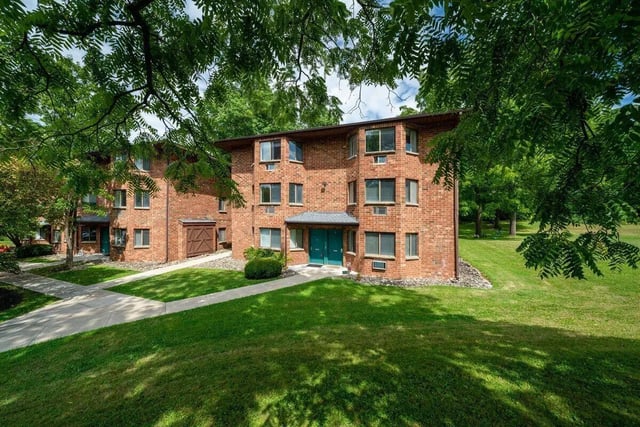 Brick apartment building with green lawn exterior at 407 College Ave in Ithaca Student Accommodation