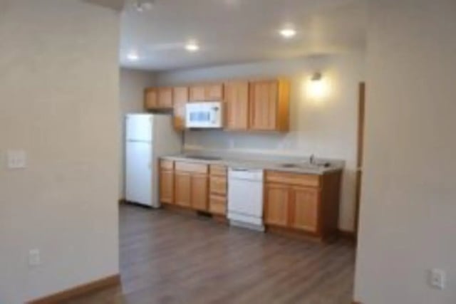 White refrigerator microwave wood cabinets kitchen area at Conifer Creek Townhomes in Allendale Student Accommodation