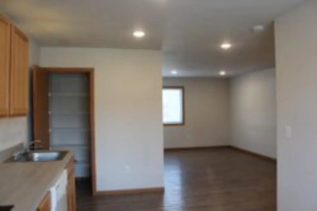Kitchen area with open door storage and living room living room at Conifer Creek Townhomes in Allendale Student Accommodation